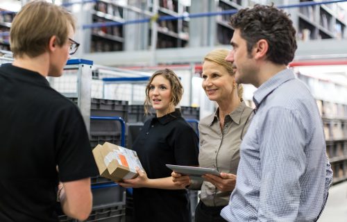 Logistics team discussing delivery schedules stock